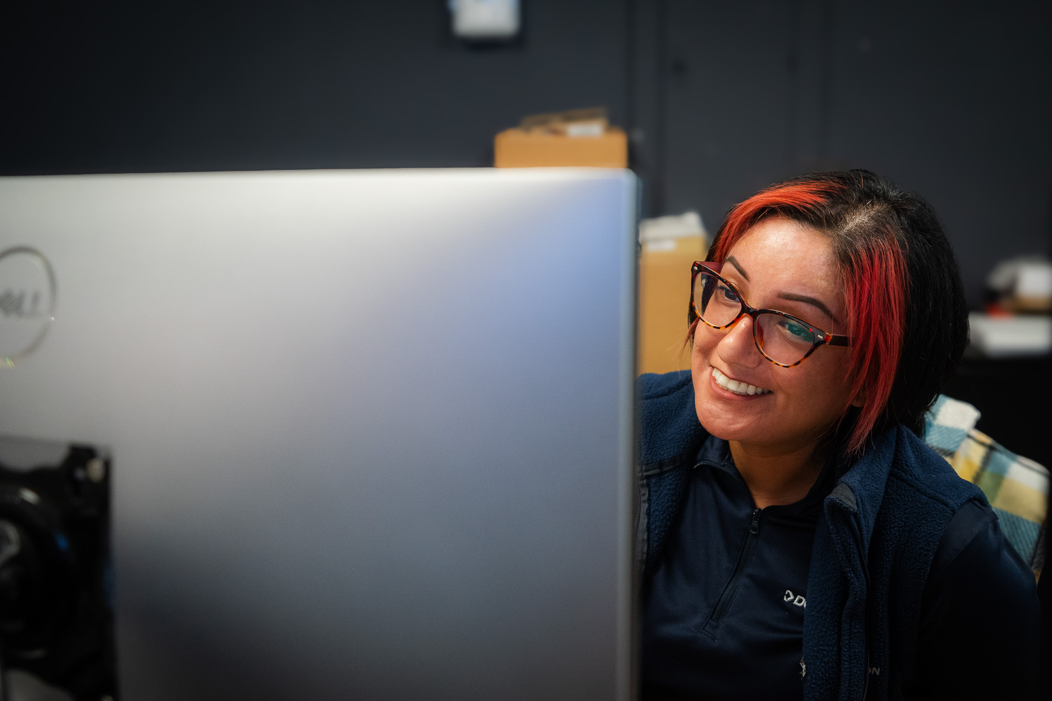 Woman smiling at computer.
