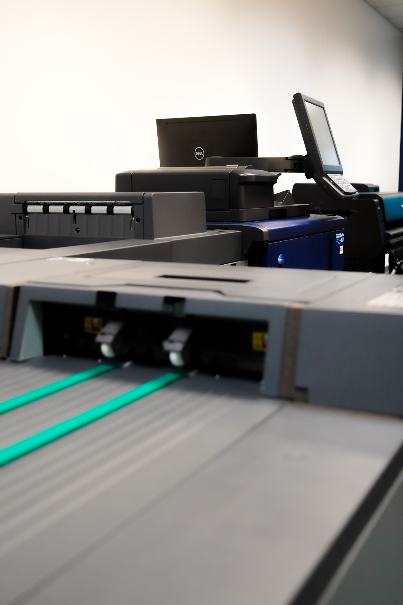 Industrial digital printing and finishing equipment in a modern production environment.
