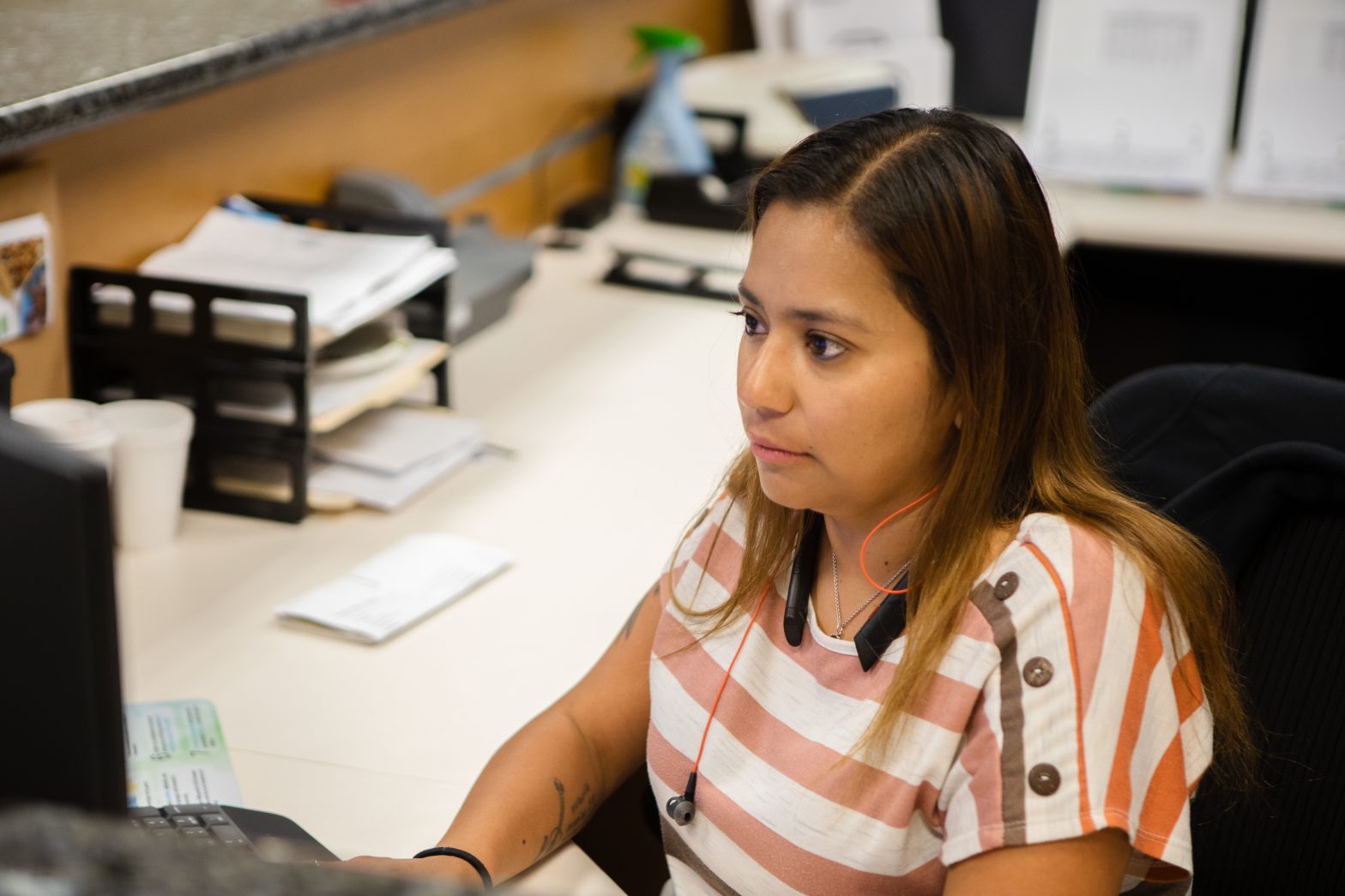 young_professional_woman_looking_at_computer_screen