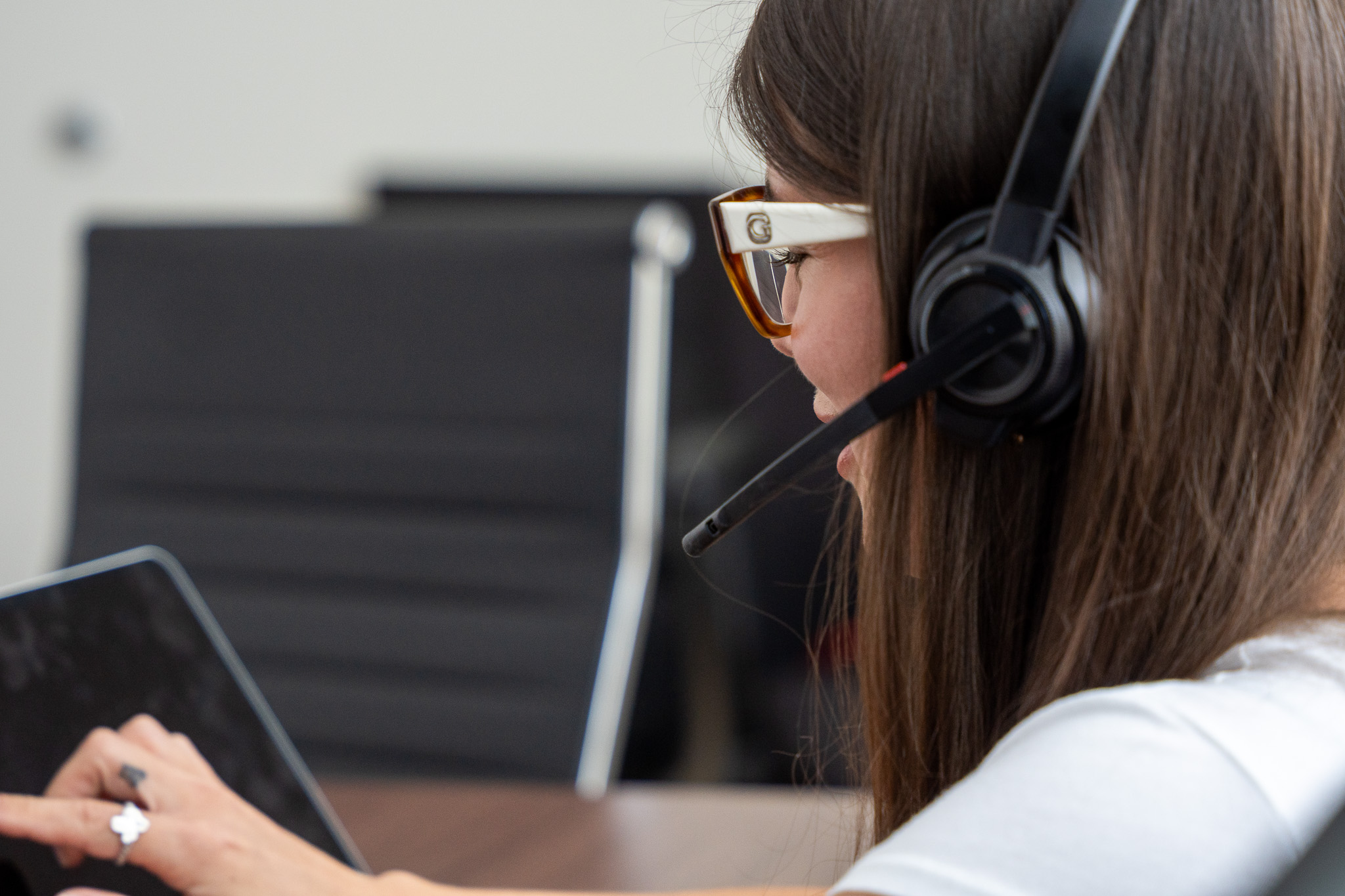 Support professional wearing a headset and working on a laptop.
