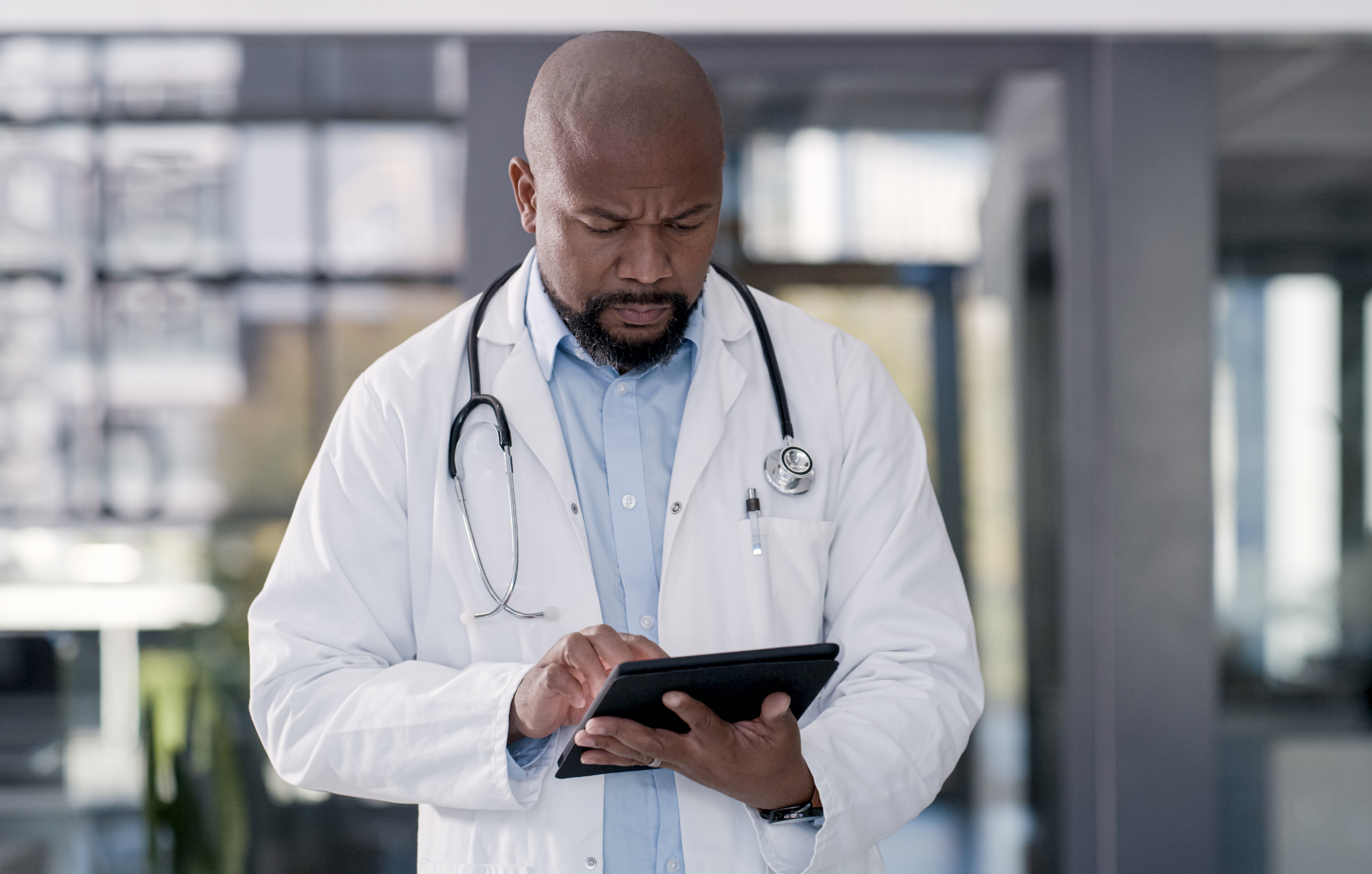 Doctor using a tablet in a hospital or clinical environment.