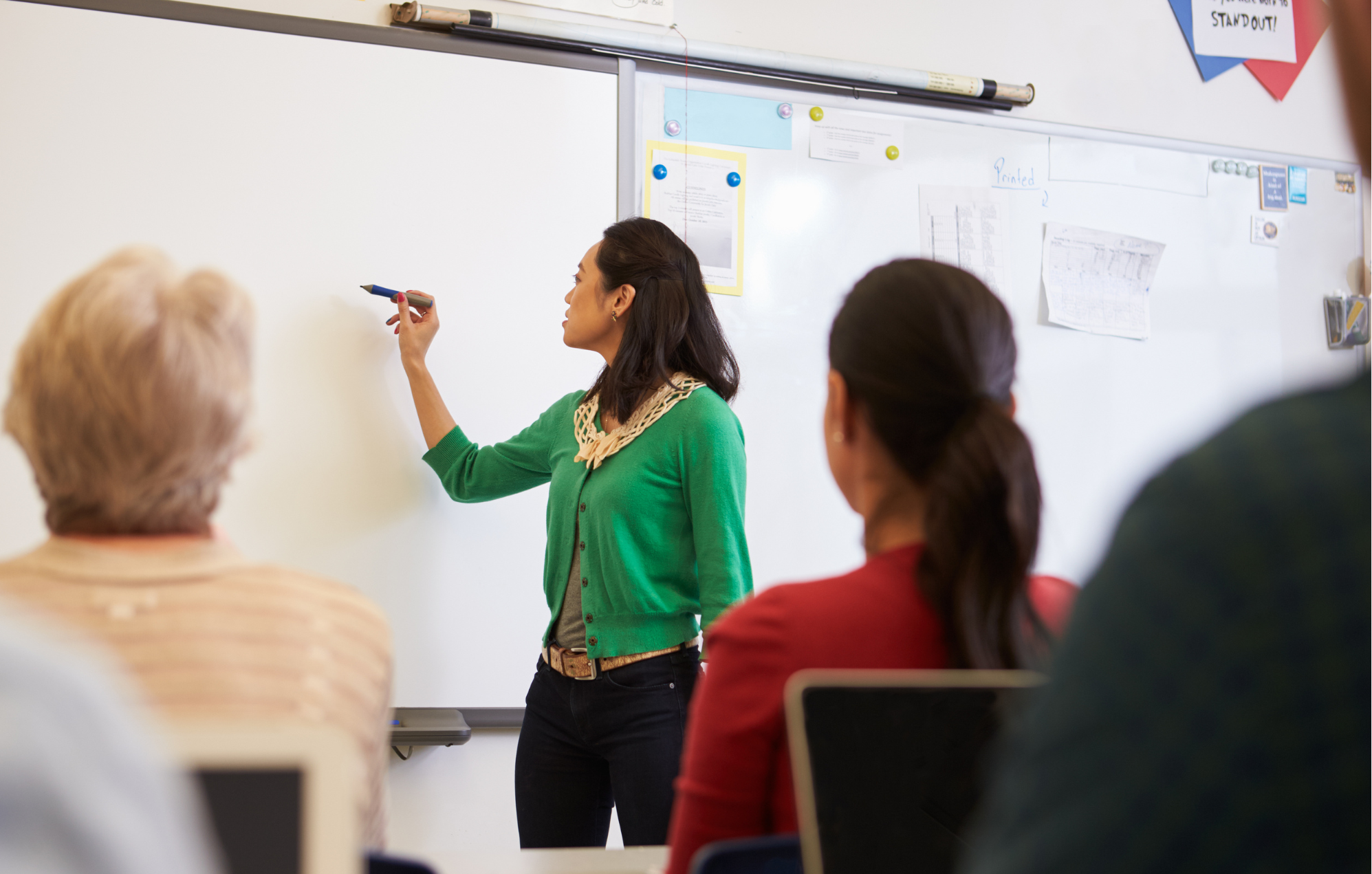 Teacher using an interactive whiteboard in a classroom supported by DOCUmation education technology.