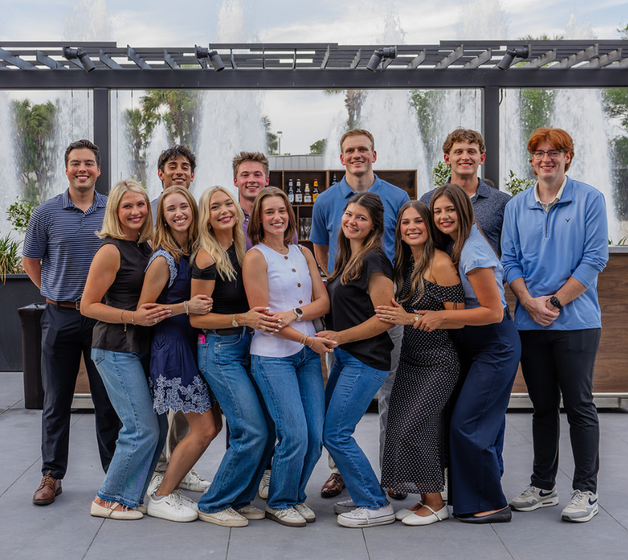 DOCUmation team members posing together outdoors during a company networking event in Texas