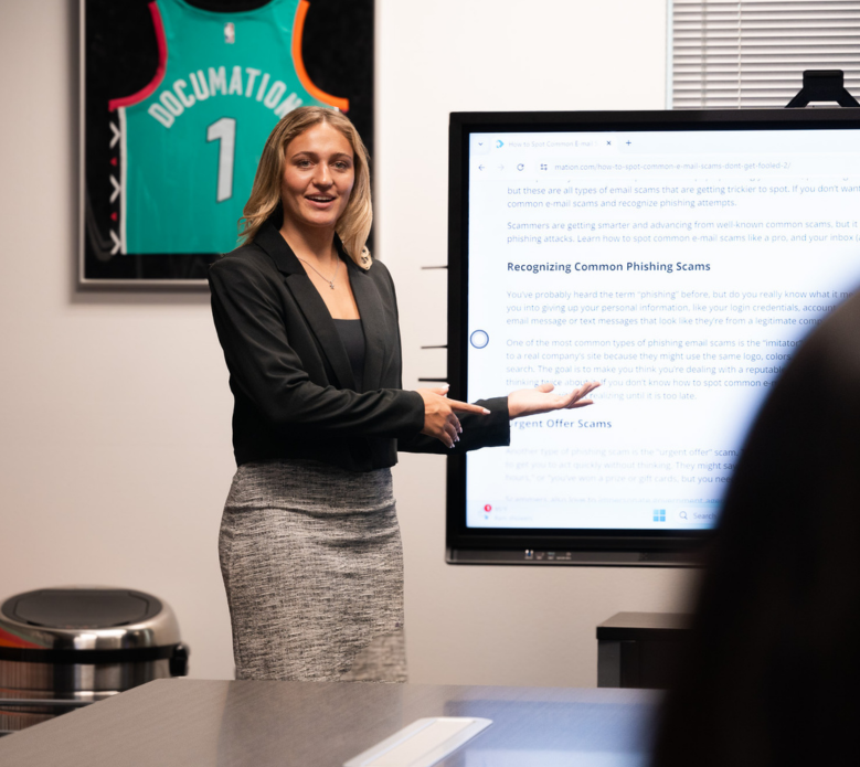 DOCUmation employee presenting cybersecurity and phishing awareness training during an office meeting